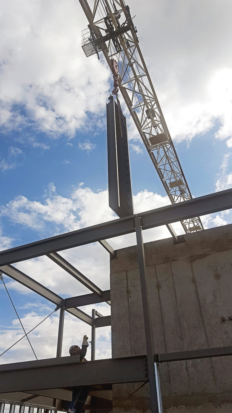 A building under construction with a crane in the background.