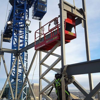 A man standing next to a crane.